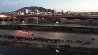 DRONE shows long queue of migrants stretching miles along US border wall