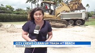 City crews clean up trash swept to Kahala Beach by heavy rains