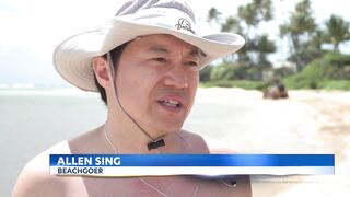 City crews clean up trash swept to Kahala Beach by heavy rains