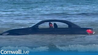 BMW washed out to sea after parking on Cornish beach