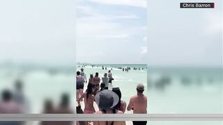 Three words a crowd of Florida beach goers didn’t expect to hear during their Sunday in the sun…...