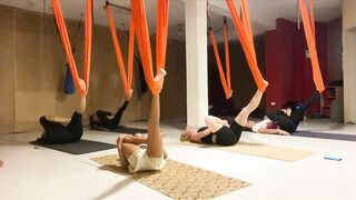 Stretching with yoga hammock on the floor | Fly yoga class