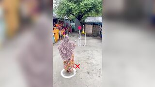 Funny challenge of throwing ball. Village Women winning useful Rewards